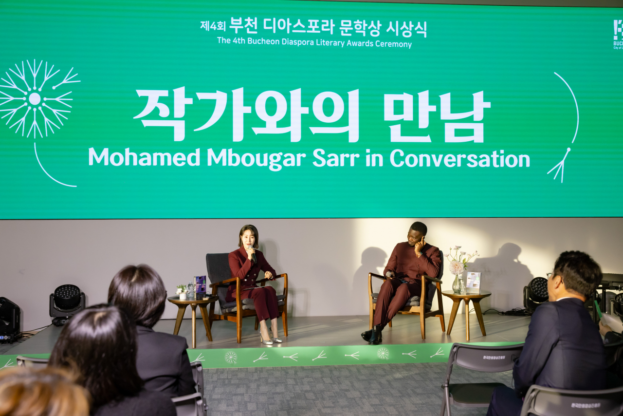 Mohamed Mbougar Sarr (right) attends a talk program at the 2024 Bucheon Diaspora Literary Award on Nov. 19. (Bucheon city)