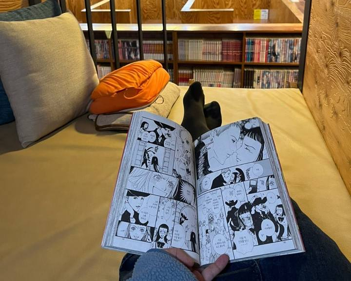 A visitor reads the Japanese comic book 