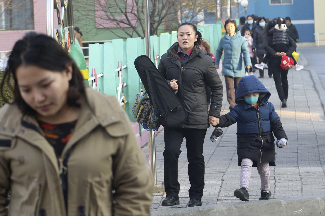 People walk along Mirae Scientists Street in Pyongyang, North Korea on Monday. AP