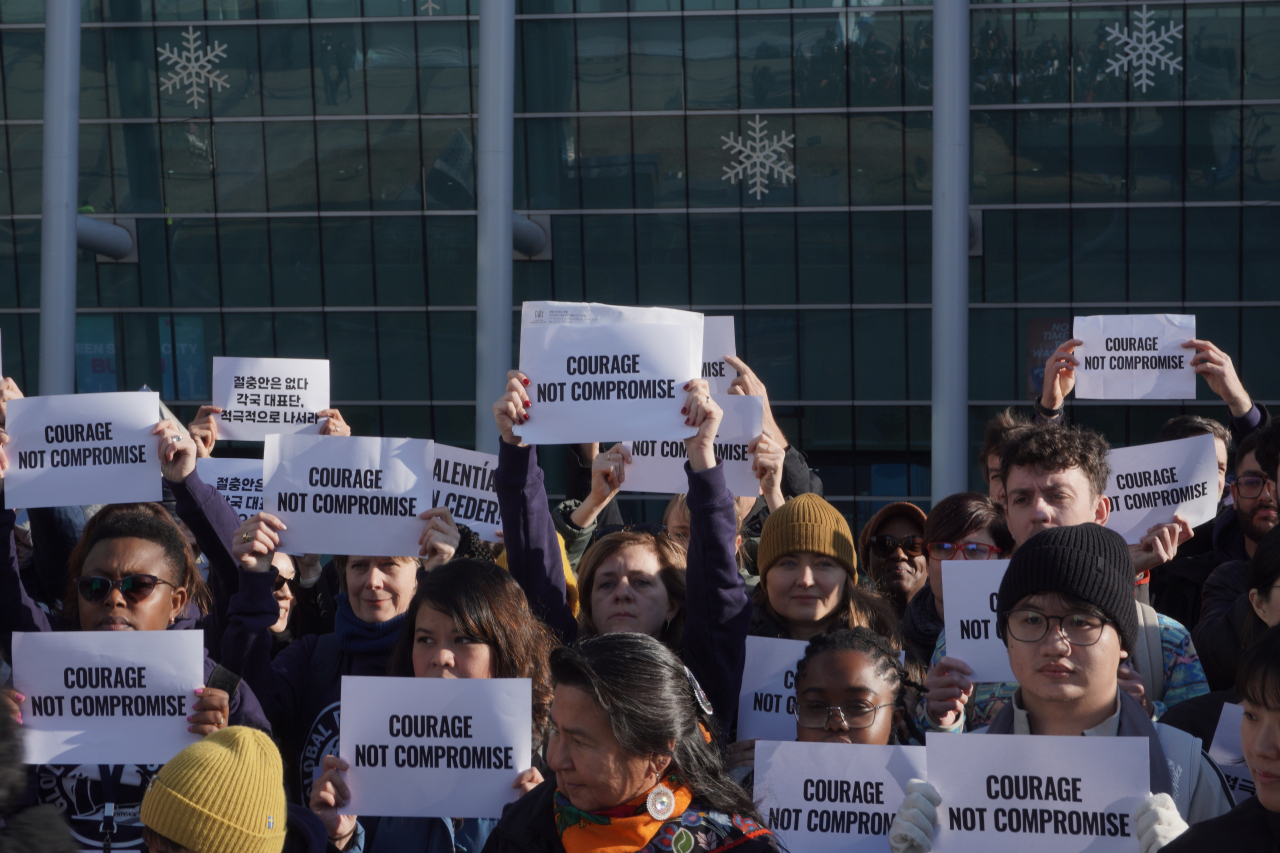 Environmental activists gather outside the venue of the 5th Intergovernmental Negotiating Committee in Busan, demanding “courage not compromise” during the final days of negotiations on plastic waste. (Courtesy of Greenpeace)