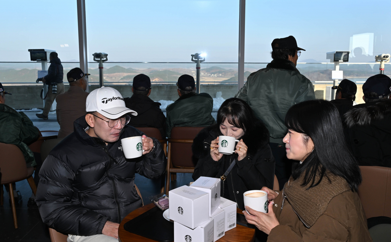 Visitors drink beverages at a Starbucks store located at the Jogang Observatory in Gimpo on Friday. (Im Se-jun/The Korea Herald)