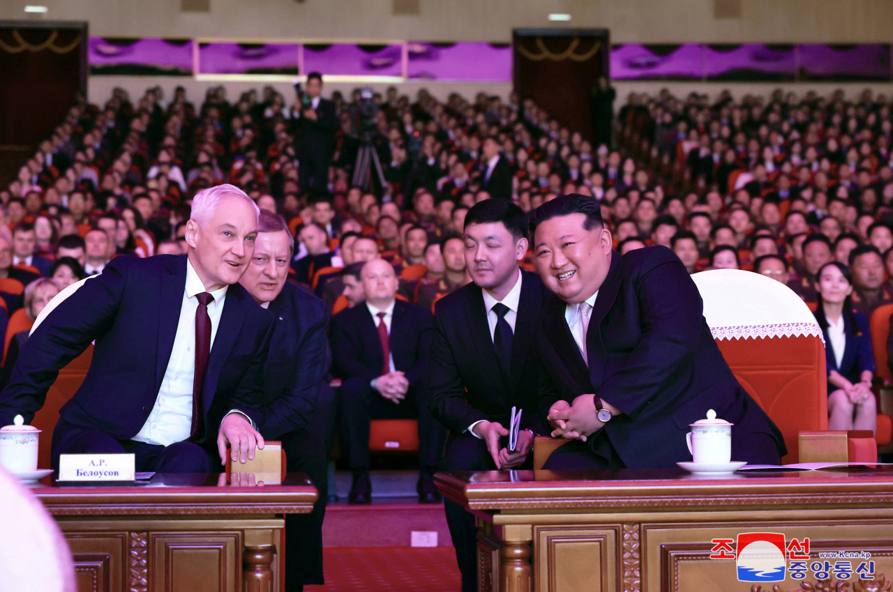 Russian Defense Minister Andrei Belousov (left) and North Korean leader Kim Jong-un watch a performance together Friday, the North’s state Korean Central News Agency reports. (Yonhap-KCNA)