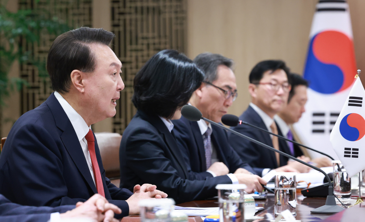 President Yoon Suk Yeol (left) speaks during the summit held at the presidential office in Seoul, Tuesday. (Yonhap)