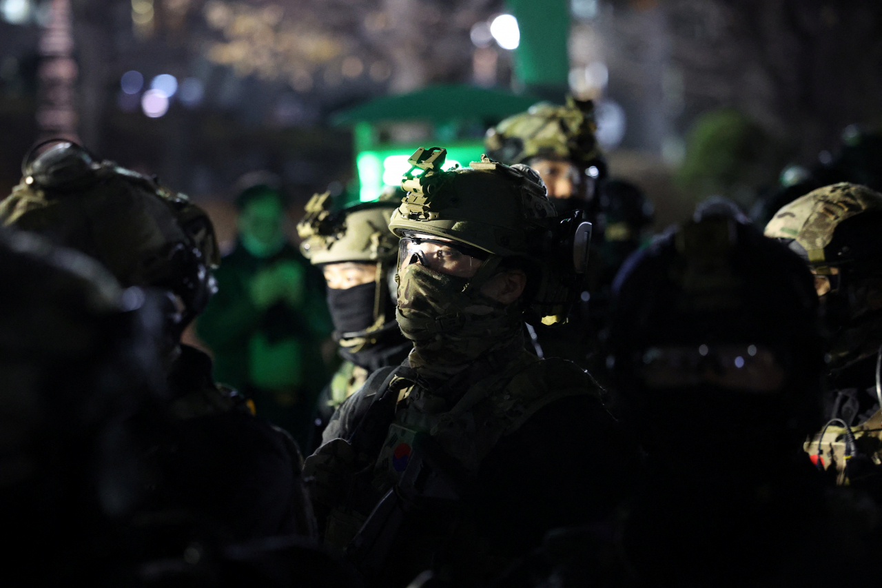 Military forces stand outside the National Assembly in Yeouido, Seoul, after President Yoon Suk Yeol declared martial law, in Seoul, Tuesday. (Reuters-Yonhap)