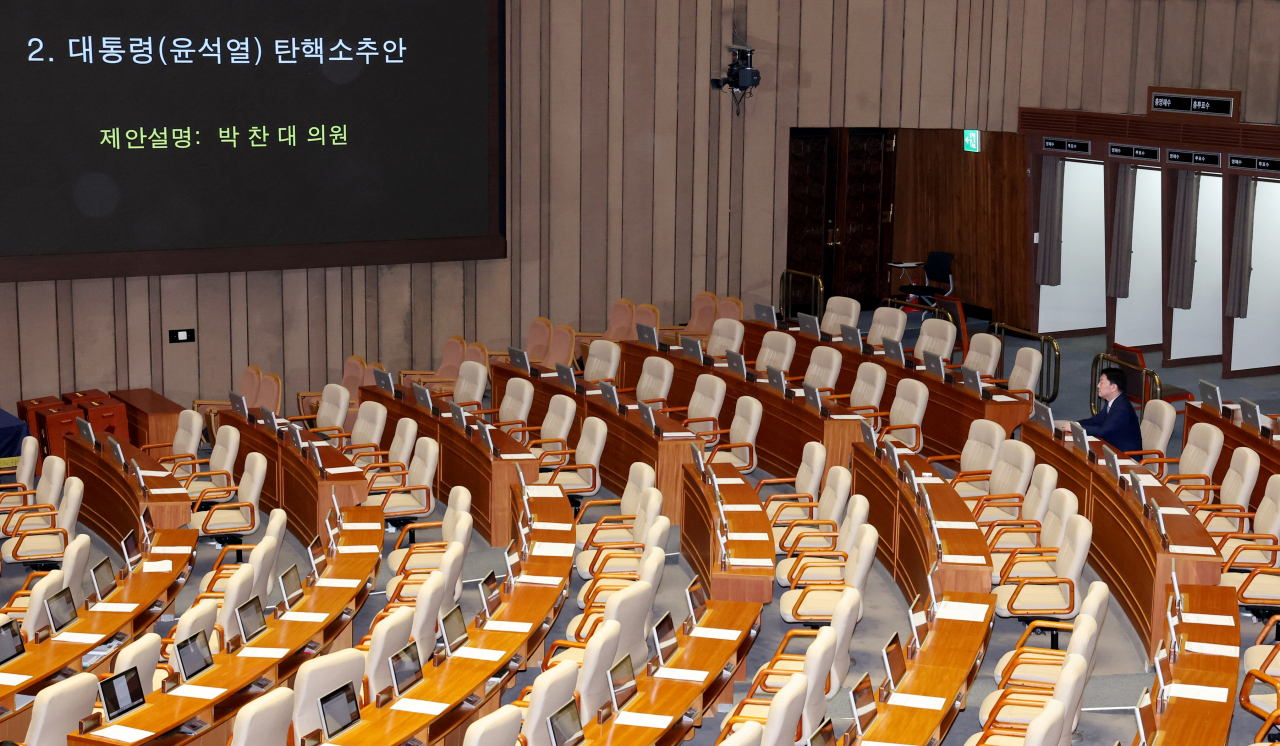 Rep. Ahn Cheol-soo of the ruling People Power Party remains seated alone at the National Assembly, while other ruling party members take part in a boycott of the vote on President Yoon Suk Yeol's impeachment on Dec. 7. (Yonhap)