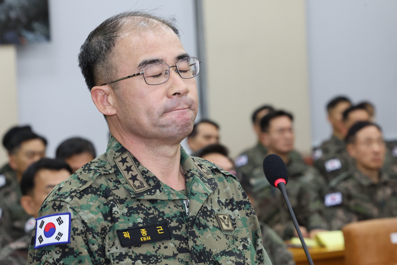 Special Warfare Commander Kwak Jong-geun closes his eyes while detailing what he said was his phone conversation with President Yoon Suk Yeol about martial law plans during a meeting of the National Assembly defense committee Tuesday afternoon. (Yonhap)