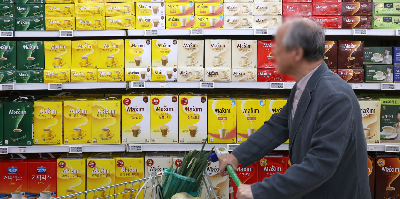 A shopper walks by a shelf stocked with coffee mix products at a supermarket in Seoul, Nov. 1. (Newsis)