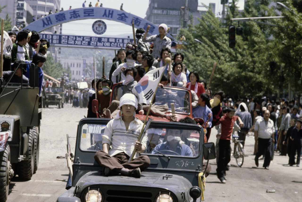 Protestors, armed with sticks, commandeer military vehicles during the Gwangju Uprising against the Chun Doo-hwan dictatorship, in the city of Gwangju, South Korea, May 21, 1980. (Getty Images)