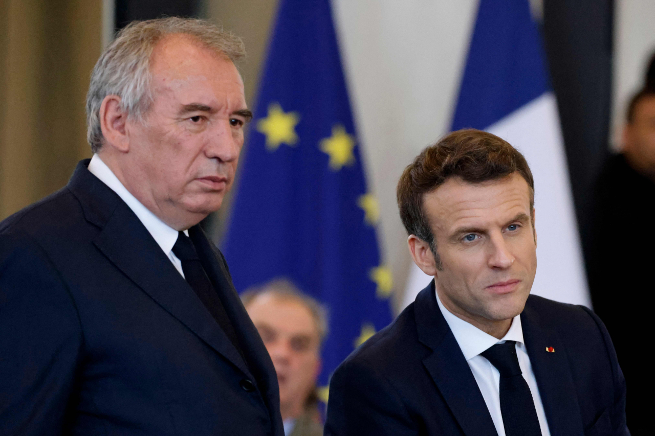 French centre-right party MoDem president Francois Bayrou (Left) and France's President Emmanuel Macron is seen during a meeting with citizens at the Palais Beaumont in Pau, southwestern France, on March 18, 2022. (Yonhap)