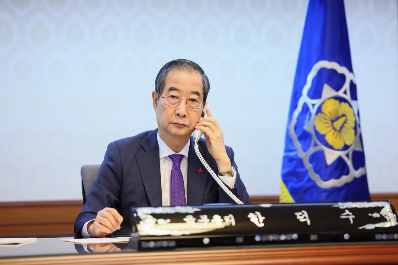 Acting President Han Duck-soo speaks with US President Joe Biden by phone at the prime minister's office in Jongno-gu, Seoul. (The Office for Government Policy Coordination, Prime Minister's Secretariat)