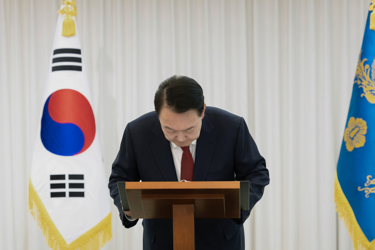 President Yoon Suk Yeol bows his head before delivering a public speech on Saturday, following his impeachment in a second vote at the National Assembly. Presidential official via Yonhap