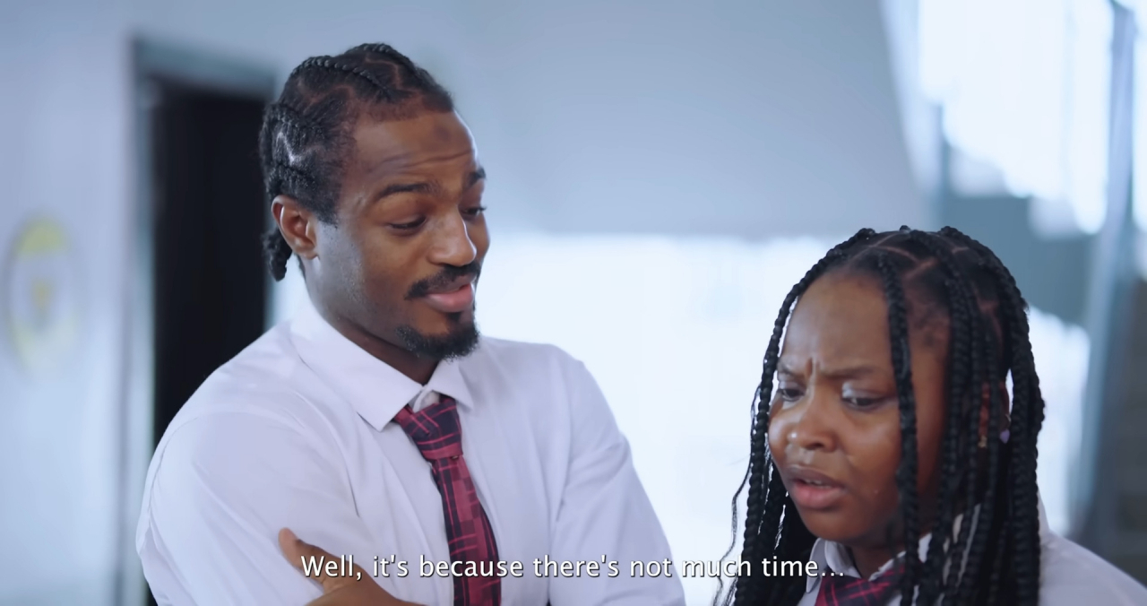 Gerald (left) playfully nudges Charis Benson to join him at his house for their group project, casually justifying it with a Korean phrase meaning “There’s not much time,” while Charis remains visibly unsure. (YouTube)