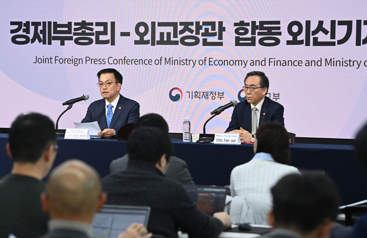 Finance Minister Choi Sang-mok (left) speaks during the joint press conference at Press Center in Jung-gu, Seoul, Wednesday. On the right is Foreign Minister Cho Tae-yul. (Joint Press Corps via Yonhap)