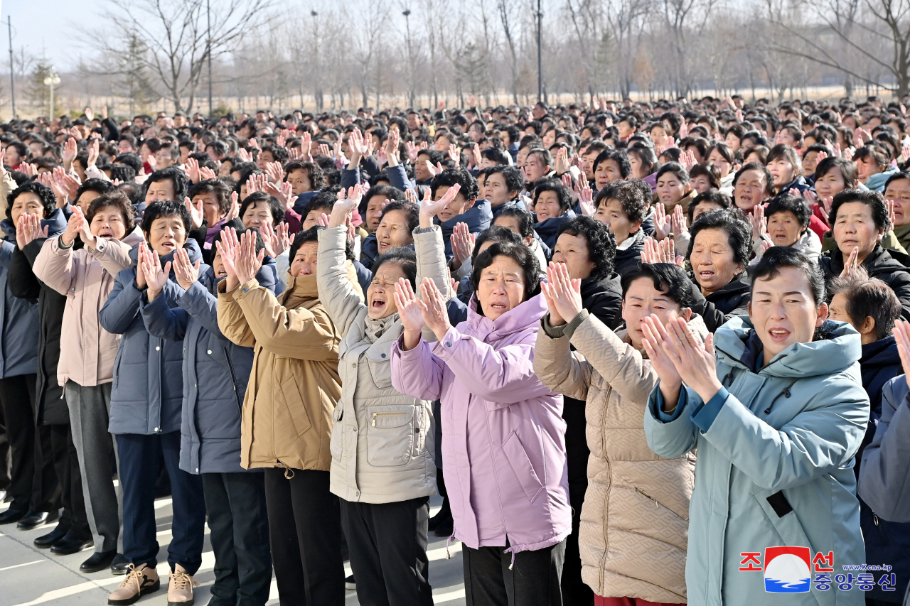 This photo, carried by North Korea's official Korean Central News Agency on Thursday, shows victims of late July's floods in the country's northern border regions who were brought to Pyongyang attending an event to recite their letters of thanks to North Korean leader Kim Jong-un the previous day. (Yonhap)