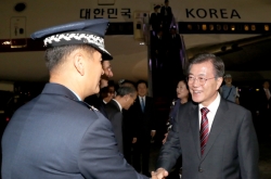 Moon returns home after Russia visit