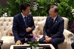 Moon, Abe agree to seek resolution to trade issues