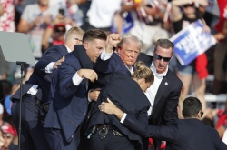 Trump is fine, campaign says, after being whisked off stage following apparent gunfire at rally