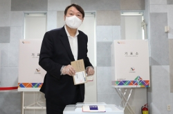 Yoon casts early ballot, fans speculations of political career