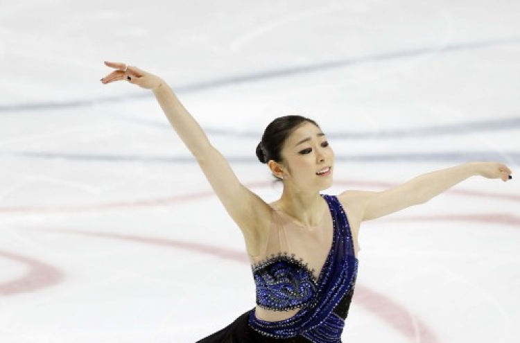 S. Korean Kim Yu-na tops short program at world figure championships