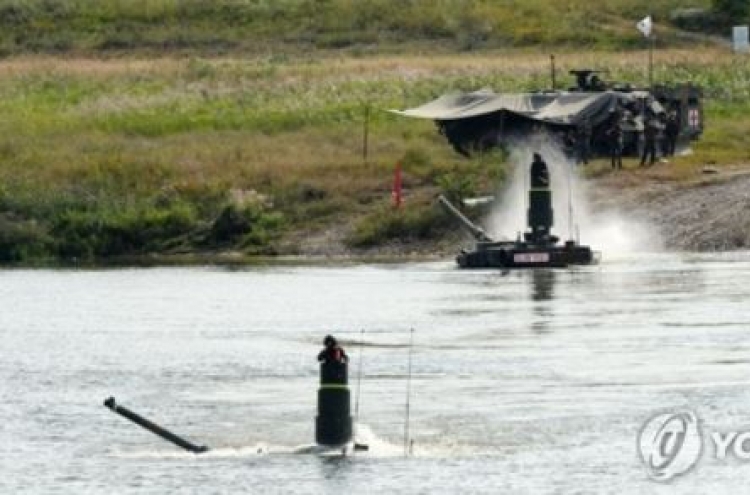 Submerged K-2 battle tanks cross river during exercise