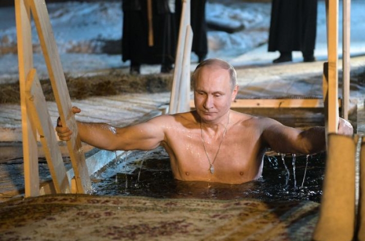 Putin takes dip in icy Russian lake on Epiphany