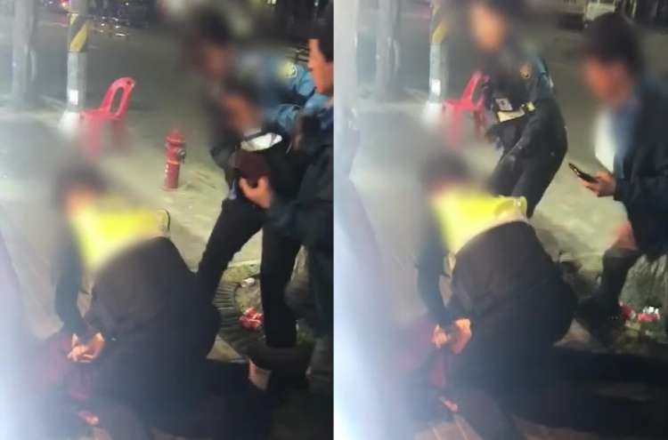 [Newsmaker] Video footage of female cop controlling drunkard sparks dispute