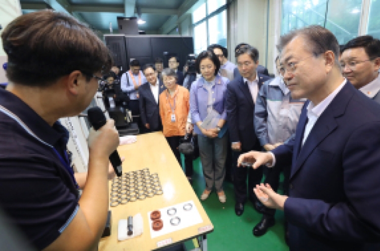 Moon visits high-tech material maker amid trade fight with Japan
