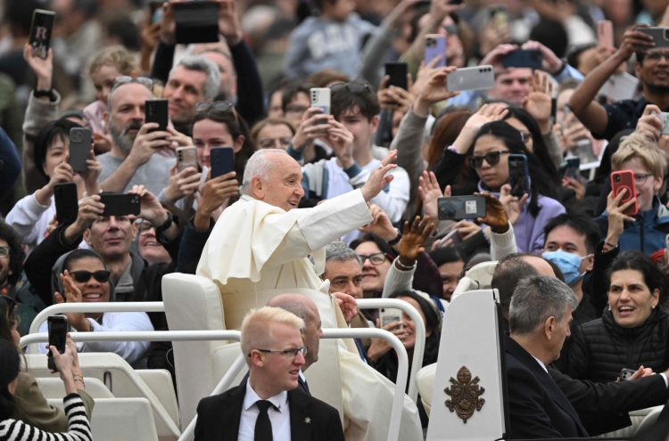 Pope overcomes health concerns to preside over a blustery Easter Sunday Mass in St. Peter's Square