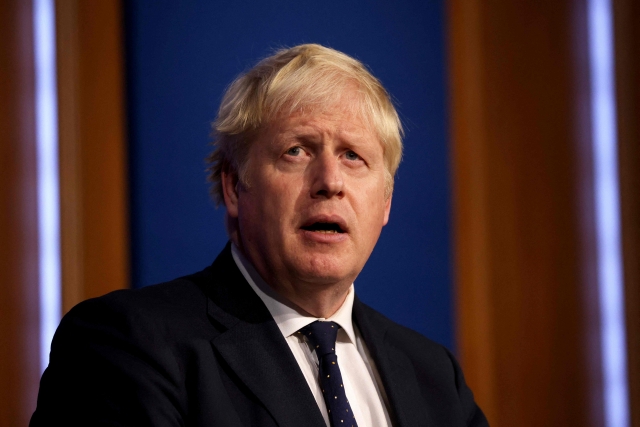 Britain's Prime Minister Boris Johnson speaks during a media briefing on the latest Covid-19 update, at Downing Street, central London on September 14, 2021. - Frontline health and social care workers, older people and the clinically vulnerable in Britain will start to receive a booster jab against Covid 19 from next week, the government said on Tuesday. (Photo by Dan Kitwood / various sources / AFP)