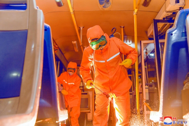 This file photo, released by North Korea's official Korean Central News Agency on June 4, 2022, shows workers sterilizing the inside of a train in Pyongyang. (Yonhap)