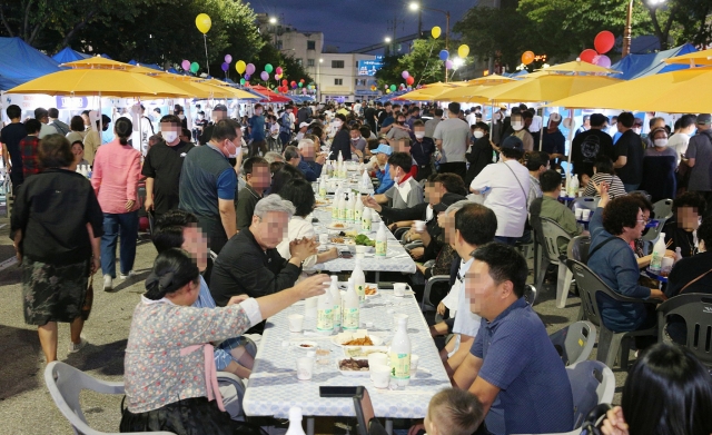 This photo taken on Saturday, and provided by Donghae City shows people participating in a makgeolli festival held in Donghae, Gangwon Province, amid eased virus curbs. Makgeolli is Korean rice wine. (Donghae City)