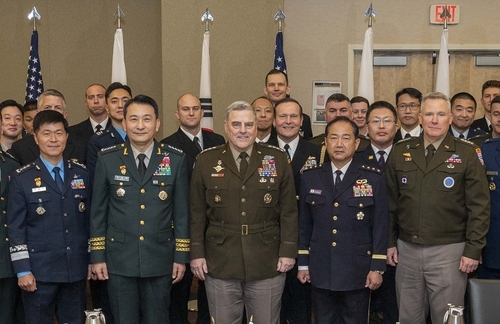 South Korea's Joint Chiefs of Staff (JCS) Chairman Gen. Kim Seung-kyum (second from left), his US counterpart, Gen. Mark Milley (center), and his Japanese counterpart, Gen. Koji Yamazaki (second from right), pose for a photo after trilateral talks in Washington on Thursday, in this photo provided by Seoul's JCS. (Seoul's JCS)