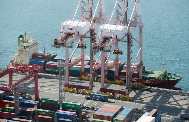 Shipping containers are stacked at a pier in South Korea's largest port city of Busan on Tuesday. (Yonhap)