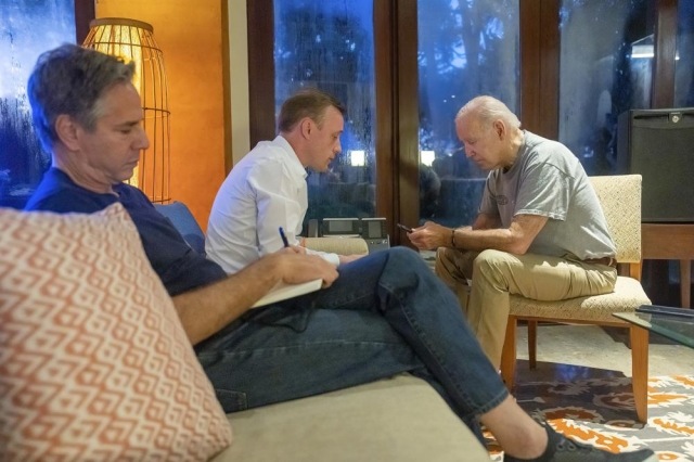 In this photo, President Joe Biden talks on the phone with Polish President Andrzej Duda as White House national security adviser Jake Sullivan, center, and Secretary of State Antony Blinken listen on Wednesday, in Nusa Dua, Indonesia. (Adam Schultz/The White House via AP)