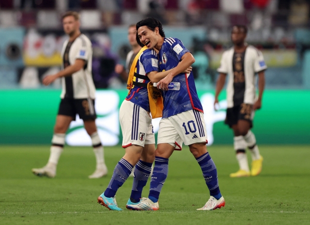 Japan's Takumi Minamino celebrates after the match on Wednesday. (REUTERS/Matthew Childs)