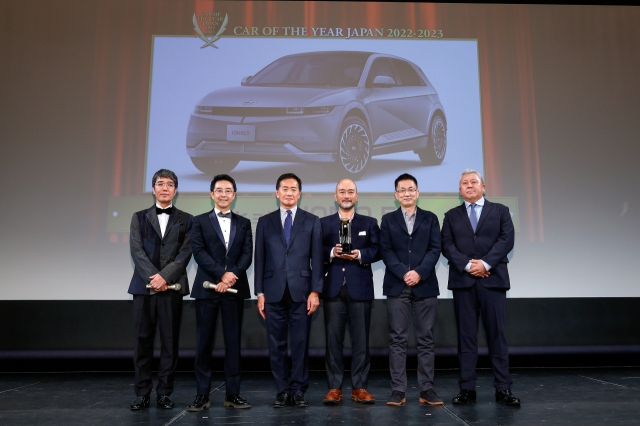 Comedian duo Hiroaki and Ken Yahagi (left), Managing Director Shigeaki Kato at Hyundai Mobility Japan, Takao Urabe, design team leader at Hyundai Mobility Japan R&D Center, and Ken Sato, senior product specialist at Hyundai Mobility Japan, pose for a picture at the Japan Car of the Year Award in Yokohama Landmark Tower in Japan on Thursday. (Japan Car of the Year Executive Committee)