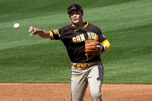 San Diego Padres' Ha-Seong Kim warms up during the second inning of a spring training baseball game against the Los Angeles Angels, last Friday, in Tempe, Ariz. (AP Photo/Matt York)