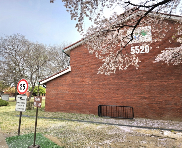 Signage in English in front of a red brick townhouse (Choi Jae-hee / The Korea Herald)