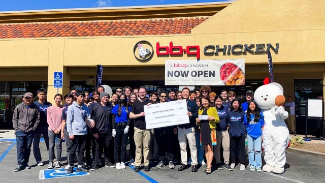 Genesis BBQ staff pose for a photo with students from Fountain Valley High School during a donation ceremony in front of the new restaurant in Fountain Valley, California. (Genesis BBQ)