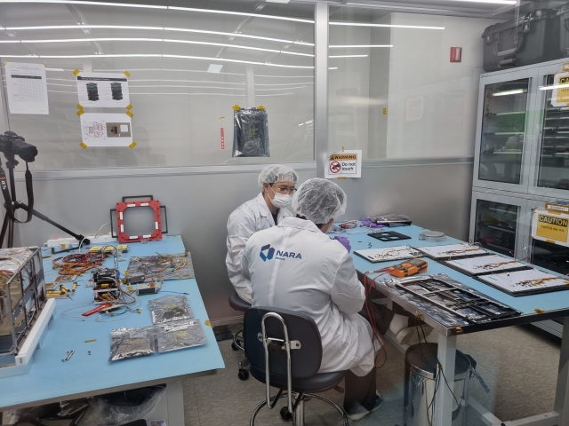 Researchers at Nara Space work on a satellite at the company's office in Seoul on May 2. (Kan Hyeong-woo/The Korea Herald)