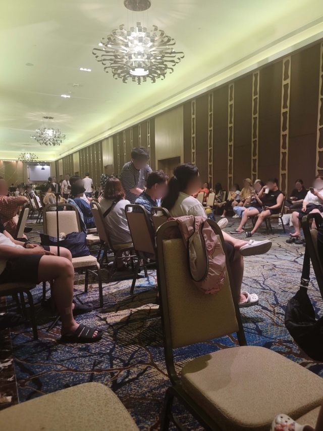 Korean tourists are gathered in a hotel banquet room, awaiting extra rooms after Typhoon Mawar hit the island, Thursday. (Yonhap)