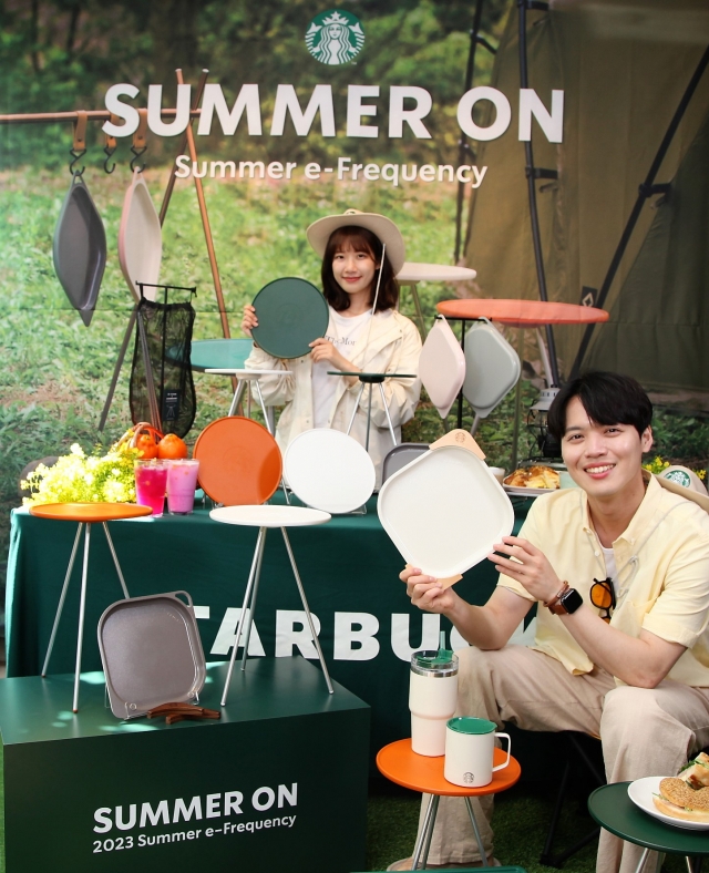 Models pose with camping gear to promote Starbucks' 2023 Summer e-Frequency giveaway event. (Starbucks Korea)