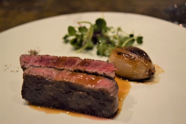 Hanwoo pepper steak served with stuffed onion created by chef Pascal Barbot (Kim Hae-yeon/The Korea Herald)