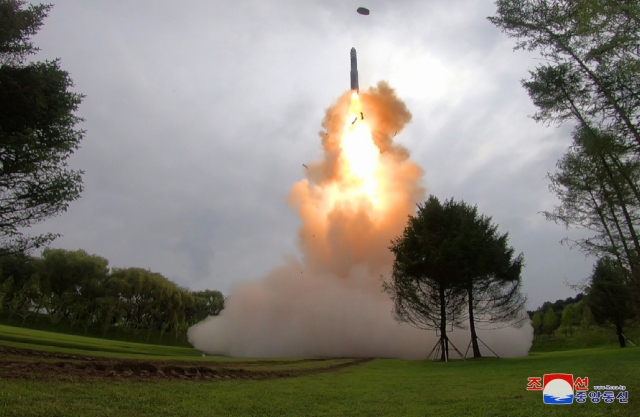 North Korea fires a Hwasong-18 solid-fuel intercontinental ballistic missile (ICBM) on Wednesday in this photo released by North Korea's state-run Korean Central News Agency. (Yonhap)