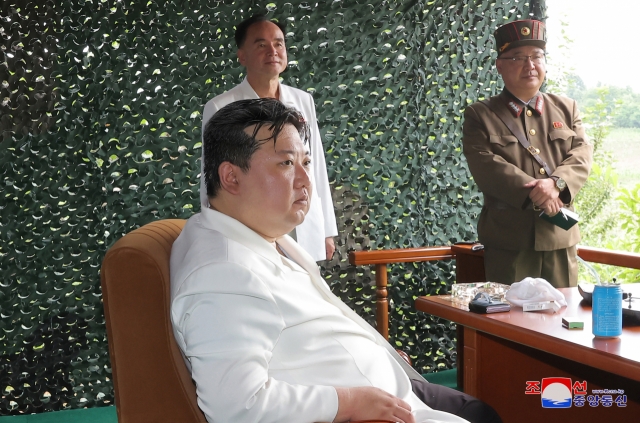 North Korean leader Kim Jong-un (front) inspects the launch of a Hwasong-18 solid-fuel intercontinental ballistic missile on Wednesday in this photo released by the North's official Korean Central News Agency. (Yonhap)