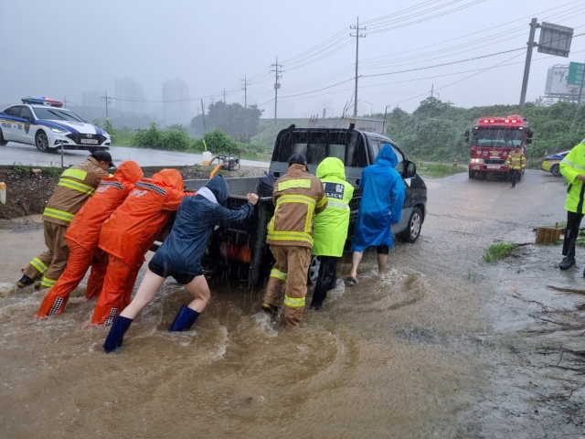 Fire authorities conduct a rescue operation in Busan on Sunday. (Busan Metropolitan City)