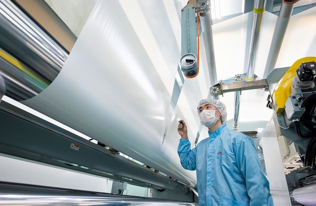 An SK Innovation employee inspects battery separator films. (SK Innovation)