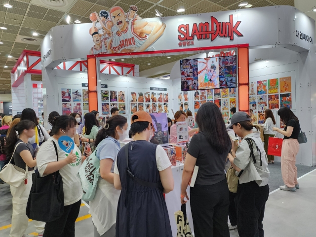 Visitors line up for the booth set up for 