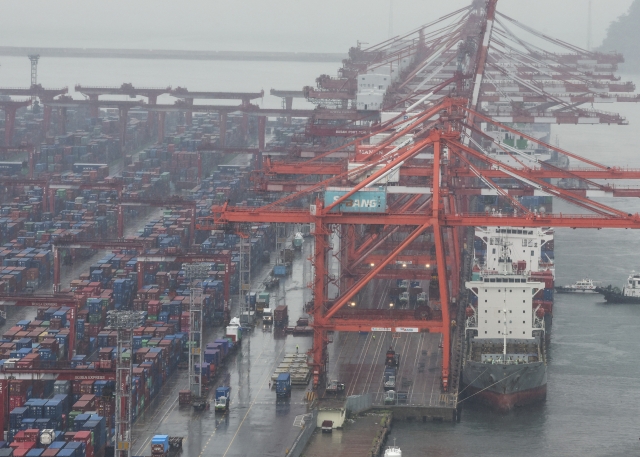 Containers are being unloaded from ships at a port in the southeastern city of Busan on Sept. 1. (Yonhap)