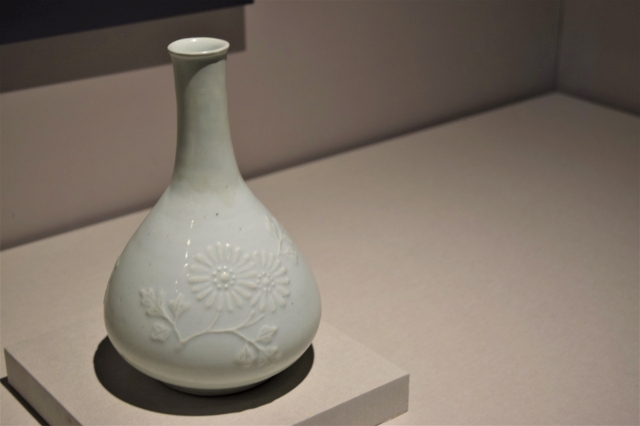 19th-century white porcelain bottle with chrysanthemum relief which symbolizes the well-being and health of its owner (Kim Hae-yeon/ The Korea Herald)